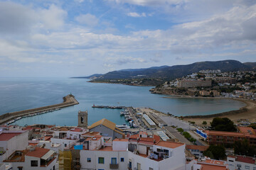 Fototapeta na wymiar View from castle of Peniscola to, landmark of the city. Turquoise bay of Mediterranean Sea, bright, colours, sunny day. Popular travel destinations, touristic place. Costa del Azahar, Spain