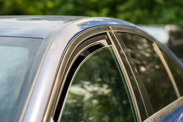 Heat, high temperature concept. Closeup of slightly ajar car window for better cooling on hot...