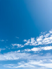 Blue sky with white clouds. Sunny spring, summer, fall, or winter weather. The photo is good for use as a background. Bright colors and good mood.