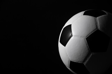 Fototapeta na wymiar Soccer ball detail on black background. Horizontal sport theme poster, greeting cards, headers, website and app.