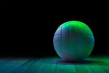 Volleyball on hardwood court floor with blue and green light. Horizontal sport theme poster, greeting cards, headers, website and app
