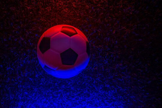 Soccer ball with neon lighting on grass background. Horizontal sport theme poster, greeting cards, headers, website and app