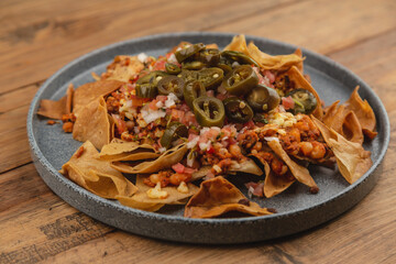 Mexican-style nachos with guacamole, pico de gallo salsa, dip, jalapeño, and cheese.




