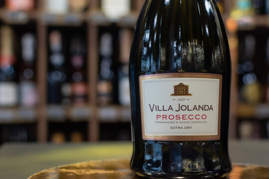 Bottle of Italian sparkling wine Villa Jolanda Prosecco Extra Dry close-up on blurred background of wine shelves. Ukraine, Zhytomyr, June, 27, 2023