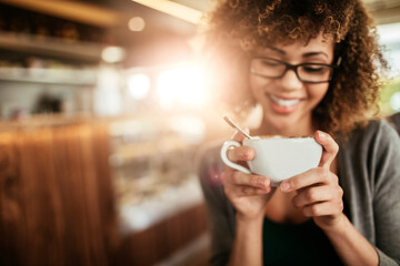 Young woman enjoying a cup of coffee in a cafe