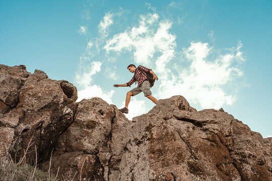 Male hiker hiking through rugged rocky mountain terrain © kieferpix