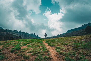Fototapeta premium Man going up a hill on the mountains