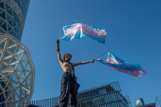 Transsexual girl protesting by waving the flag for gender freedom