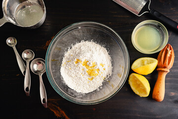 Mixing Bowl Filled with Sweet Lemon Glaze Ingredients: Glass mixing bowl with lemon glaze...