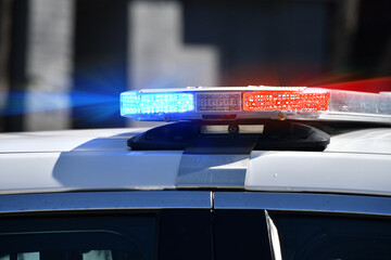 Flashing blue and red lights on a cop car, police law enforcement officer