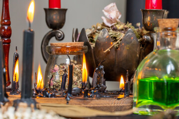 Witchcraft composition selective focus with candles lights, magic items tools and symbols.  Occult and esoteric concept. Mystic Halloween. Magic chemistry and witch craft.