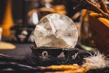 Crystal ball for fortune telling and divination ritual, mystic background. Crystal sphere in plate with magic symbols. Fortune teller, mind power and prediction Halloween background.