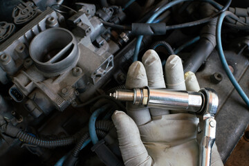 car maintenance, spark plug change operation of the internal combustion engine, in the workshop...