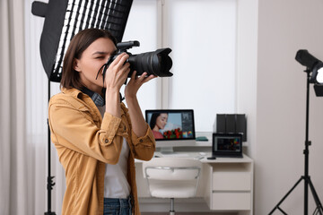 Professional photographer taking picture in modern photo studio - Powered by Adobe