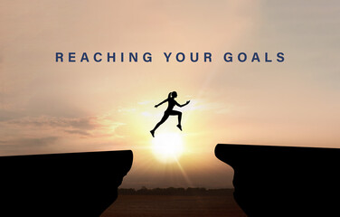 Concept of reaching life and business goals. Silhouette of woman jumping over chasm at sunrise