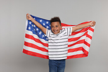 4th of July - Independence Day of USA. Happy boy with American flag on light grey background