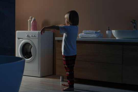 Boy in pajamas sleepwalking indoors at night