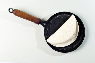 Tapioqueira  maker with a tapioca inside top view, Iron skillet, cast iron skillet, skillet for making tapioca (Frigideira de tapioca), on white background with selective focus, isolated