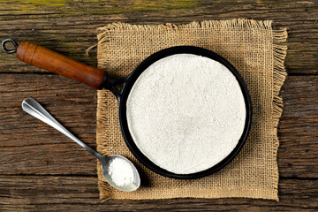 Tapioqueira  maker with a tapioca inside top view, Iron skillet, cast iron skillet, skillet for making tapioca (Frigideira de tapioca), on wooden table with selective focus, isolated