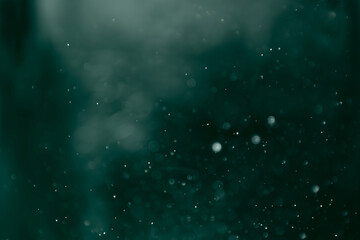 Abstract green glowing light gradient ombre on bokeh glitter background. Idea for wallpaper, card,...