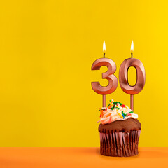 Candle with flame number 30 - Birthday card on yellow background