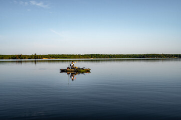 Obraz na płótnie Canvas Kayak fisherman on a lake