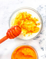 Natural face mask with turmeric powder and yogurt. Natural cosmetics on a white background