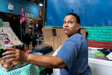 Woman merchant selling soft drinks at a typical market in Nicaragua