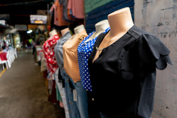 Blouses and clothing on mannequins displaying in the aisles of a popular market in Nicaragua