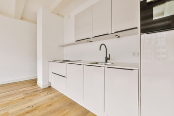 a kitchen with white cabinets and black appliances on the counters in front of the sink is empty, but there is no one
