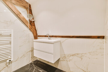 a bathroom with marble flooring and white walls, wood trim around the window simh is visible on the wall