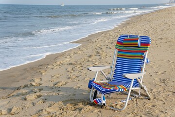 A colorful beach chair by the waves near Rehoboth Beach, Delaware, U.S.A