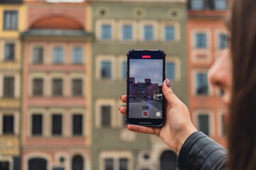 Female traveler in historical places looks around courtyard of landmark and shoots short video on...