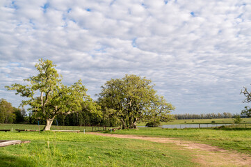 Countryside landscape at daytime, clouds and sun.