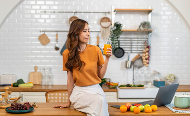 Portrait of beauty body slim healthy asian woman drinking glass of juice and orange.young girl preparing healthy drink with fresh orange juice, vitamin c, in kitchen at home.Diet.healthy drink