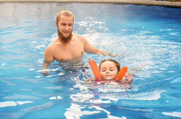 Fototapeta premium Child swim in the pool on vacation