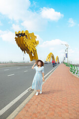 Tourist woman is enjoy traveling and sightseeing at Dragon bridge which is one of the most beautiful destination of Da Nang city,Vietnam