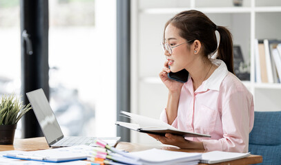 Businesswoman using mobile phone while working in modern office..