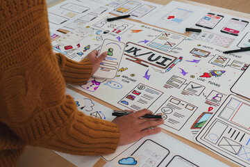 Close up ux developer and ui designer brainstorming interface wireframe design.Creative digital...