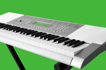 Modern synthesizer on green background, closeup