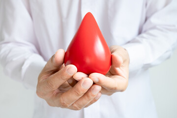 healthy man's hand holding blood symbol Blood Donation Help and Health Concepts.