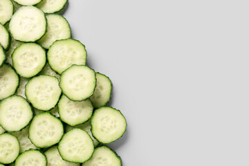 Slices of cucumber on grey background
