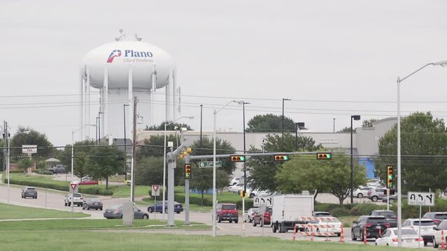 Plano, Texas water tower next to a busy road leading into the city.