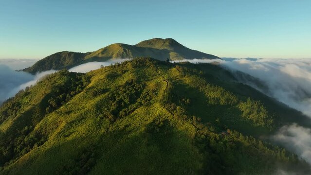 Aerial View of Mountains Above the Clouds at Sunrise. In the Mongkrang Hills, Indonesia