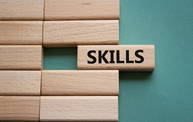 Skills symbol. Concept word Skills on wooden blocks. Beautiful grey green background. Business and...