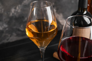 Glasses of exquisite wine on dark background