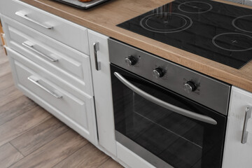 Electric oven with stove in interior of modern kitchen
