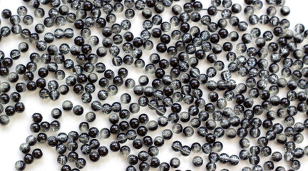 handicraft items, jewelry, beads, DIY background. Plastic acrylic glass beads of different shapes and colors for making brooches, pendants, collars. Blur effect. Weak focus.