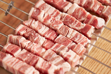 Raw lamb skewers on a plate	