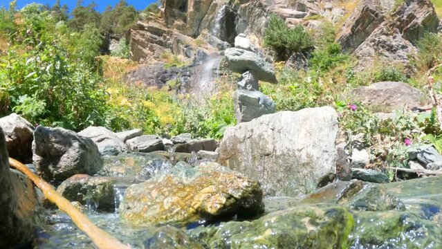 creek or spring with small waterfalls in mountain ridge forest - loop video